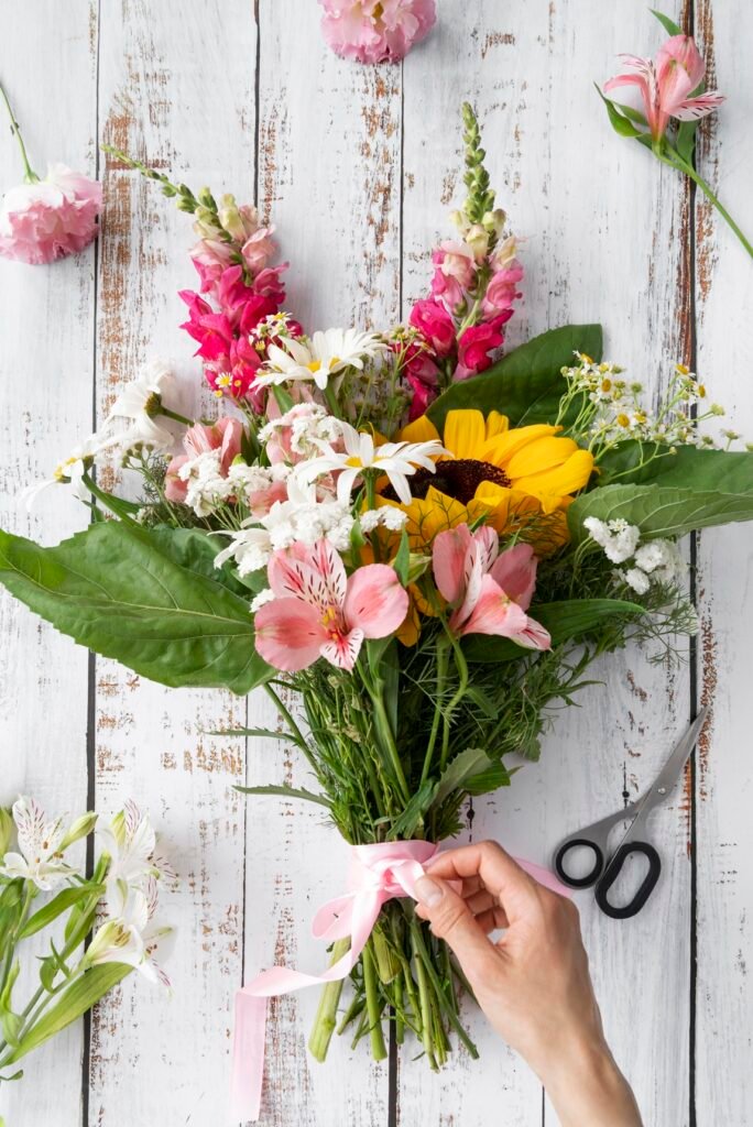 top-view-female-hand-preparing-bouquet-flowers